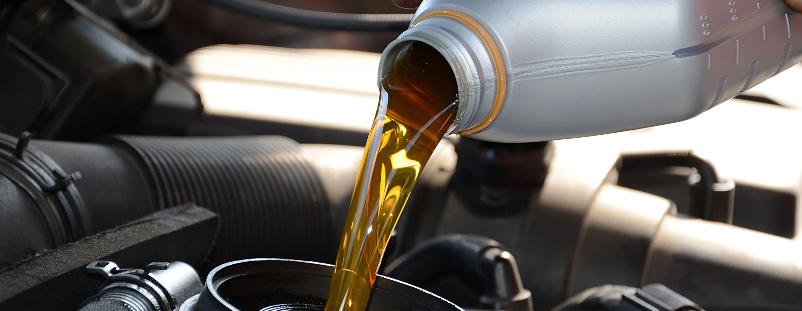 Motor oil being poured into an engine